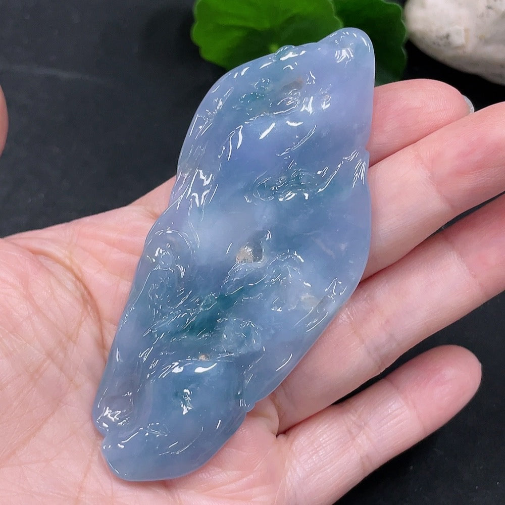 Huiliu Jadeite Enlightenment Pendant showcasing smooth, polished jade pendant with intricate carvings on a white background.