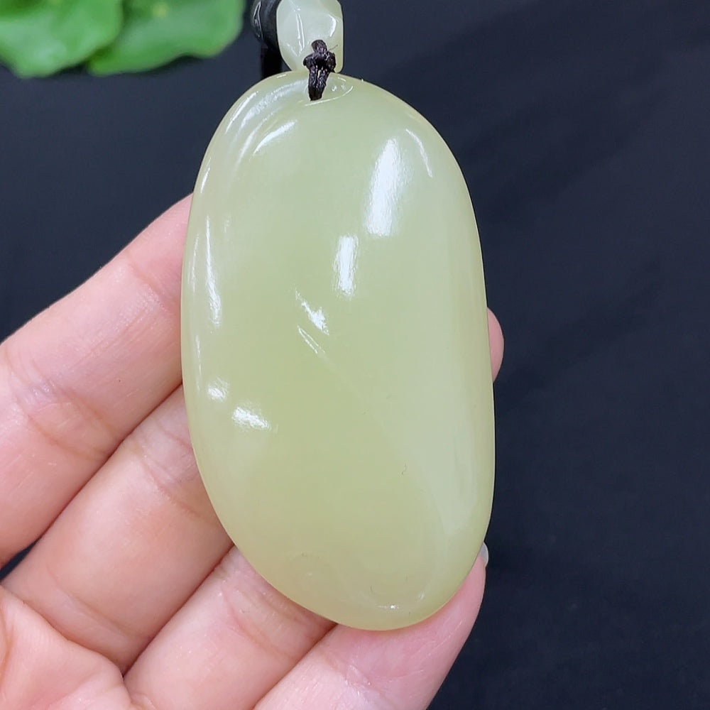 Hetian Jade freeform pendant necklace by HKHQ featuring a smooth, polished jade stone with organic shape and natural green hue.