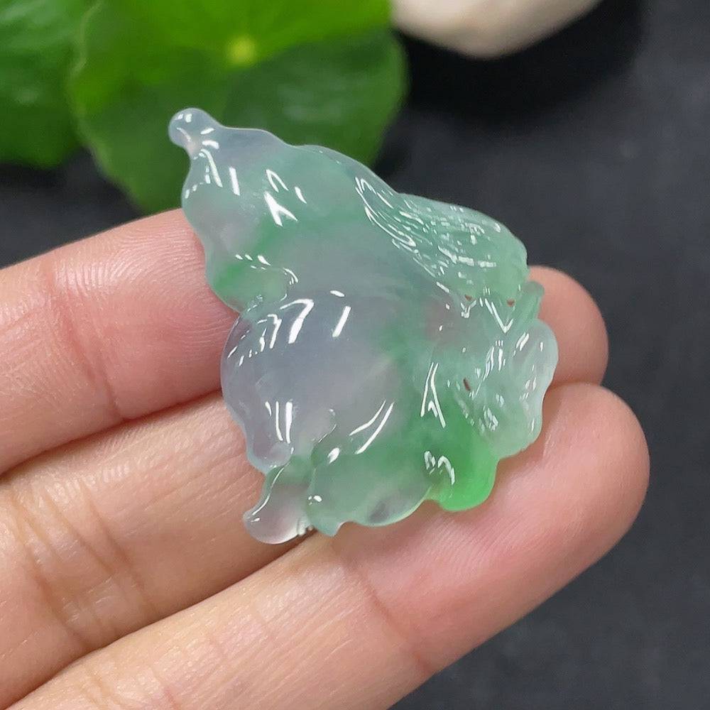Jadeite pendant shaped like a butterfly fairy with intricate carvings, crafted by HUILIU HQ in smooth green jade.
