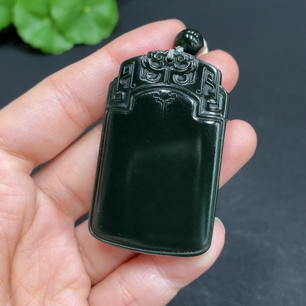 Huiliu certified Hetian jade pendant with antique plaque design and rope, showcasing intricate craftsmanship and rich jade color.