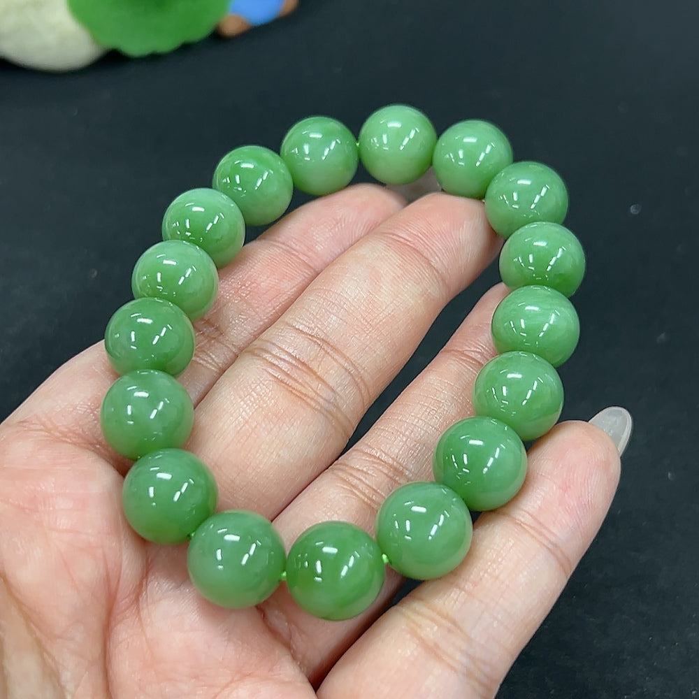 Hetian Jade Jasper bracelet featuring 11.9mm beads, crafted by HKHQ, showcasing smooth, polished jade stones on a flexible band.