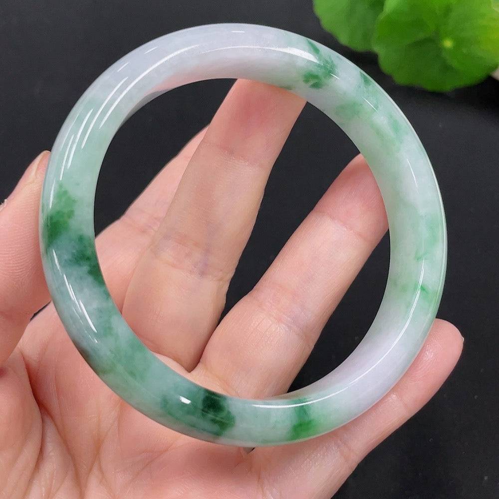Huiliu certified jadeite round bangle showcasing smooth, polished green jade with a glossy finish and intricate craftsmanship.
