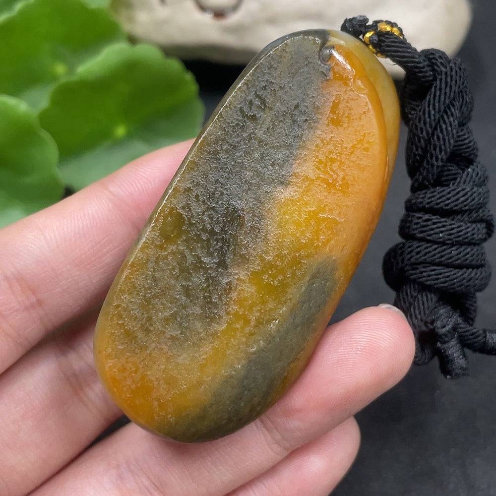 Huiliu certified Hetian jade Guanyin pendant with mineral components and rope, featuring smooth skin-tone color and detailed craftsmanship.