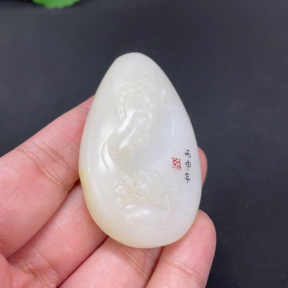 Huiliu certified Hetian jade Guanyin pendant with natural skin tone, intricate carving, and smooth polished surface.
