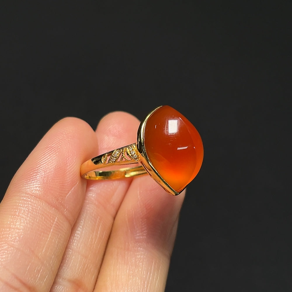 18K gold Southern Red Agate ring with diamond accents, featuring a polished red gemstone and elegant design by HKHQ.