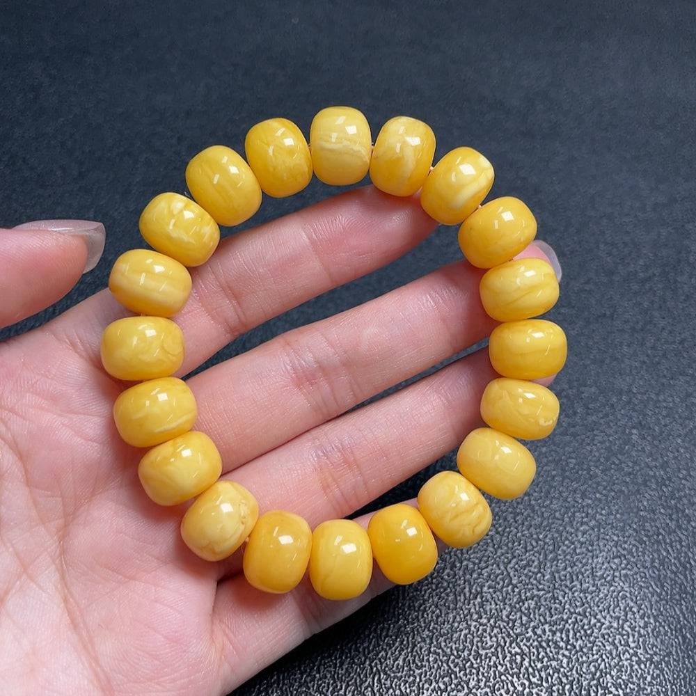 Huiliu Amber Beeswax Bracelet with 12.4mm beads, natural amber color, and certified quality, displayed on a neutral background.