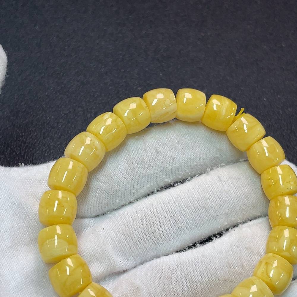 HUILIU HQ amber beeswax bracelet, approximately 16.42g, with 10.6mm beads showcasing warm amber tones and natural texture.