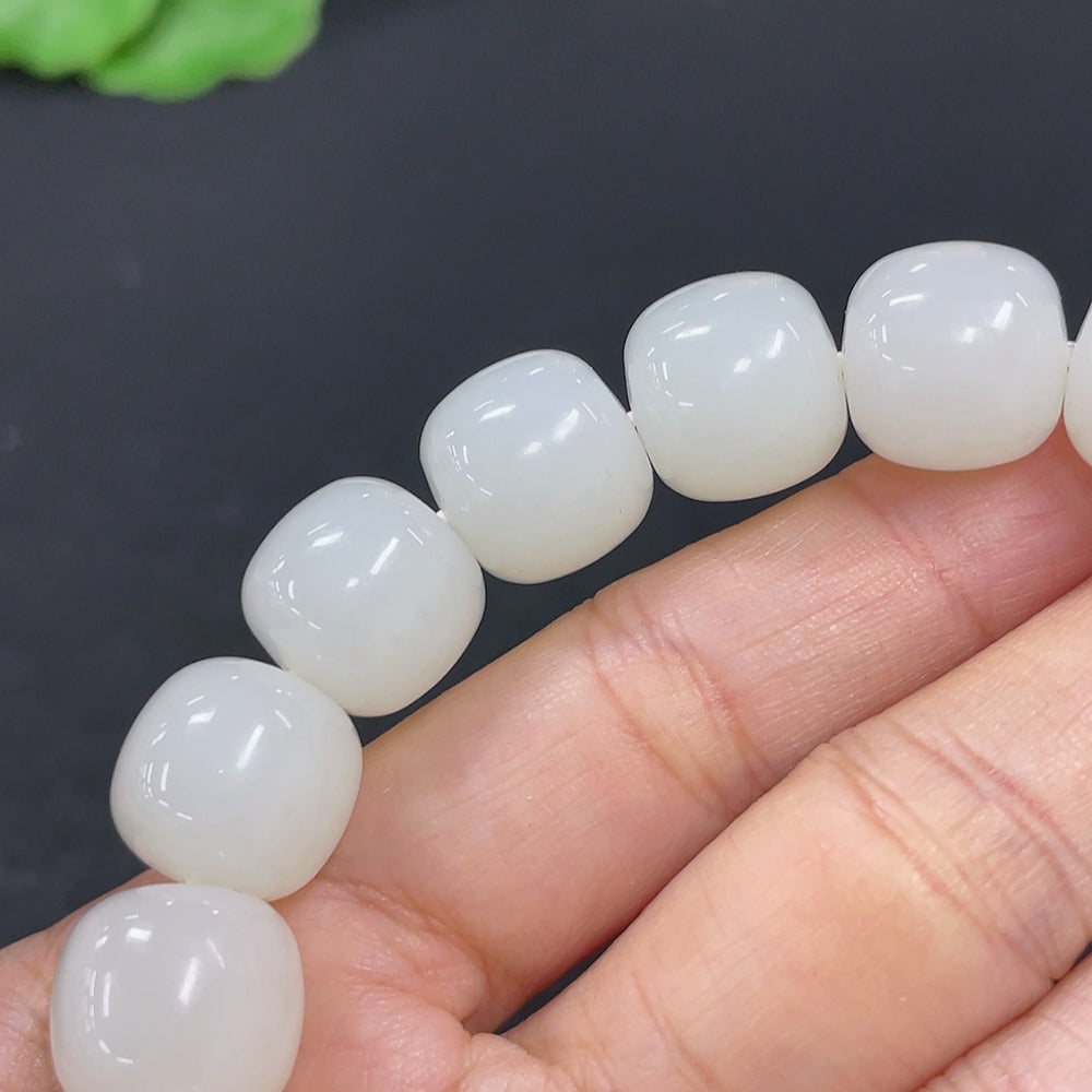 Hetian Jade bracelet from HKHQ featuring smooth, polished jade beads with a subtle green hue, weighing 60.5 grams.