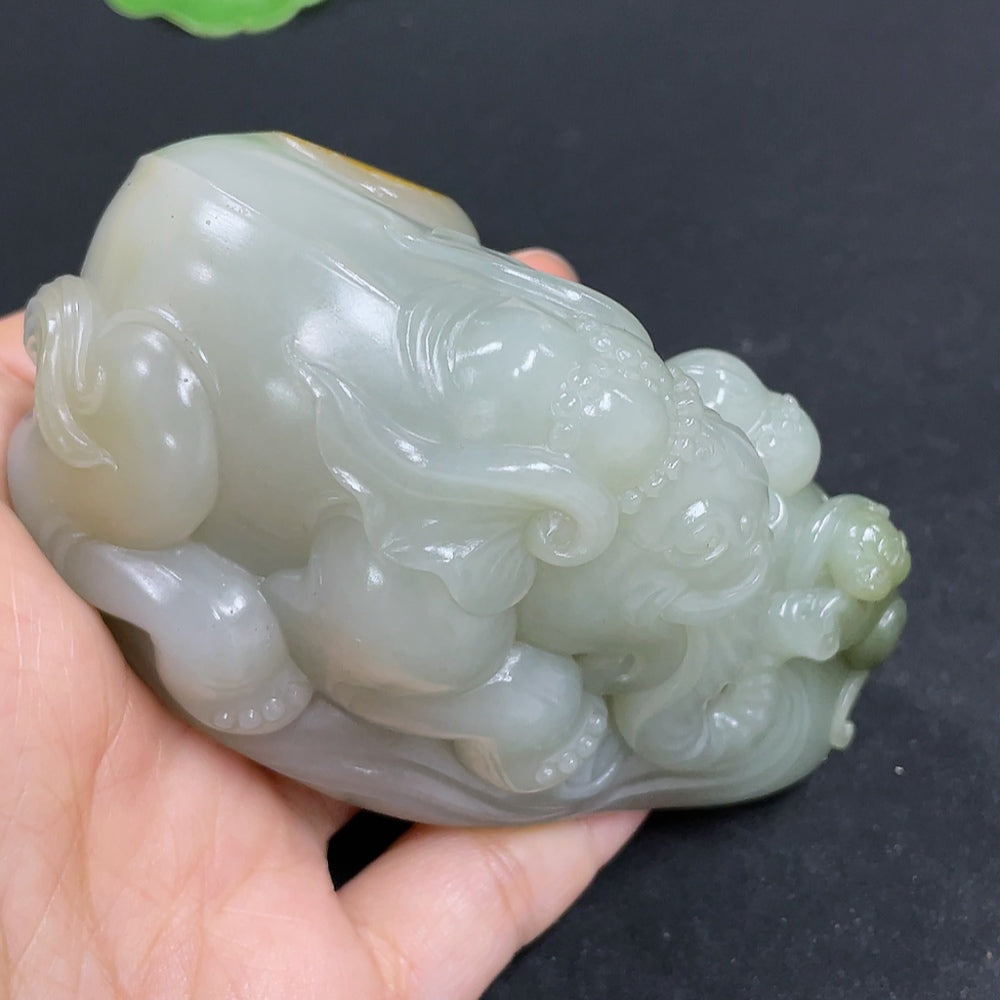 Hetian jade seed material hand piece by HKHQ featuring intricate jade craftsmanship and a polished finish.
