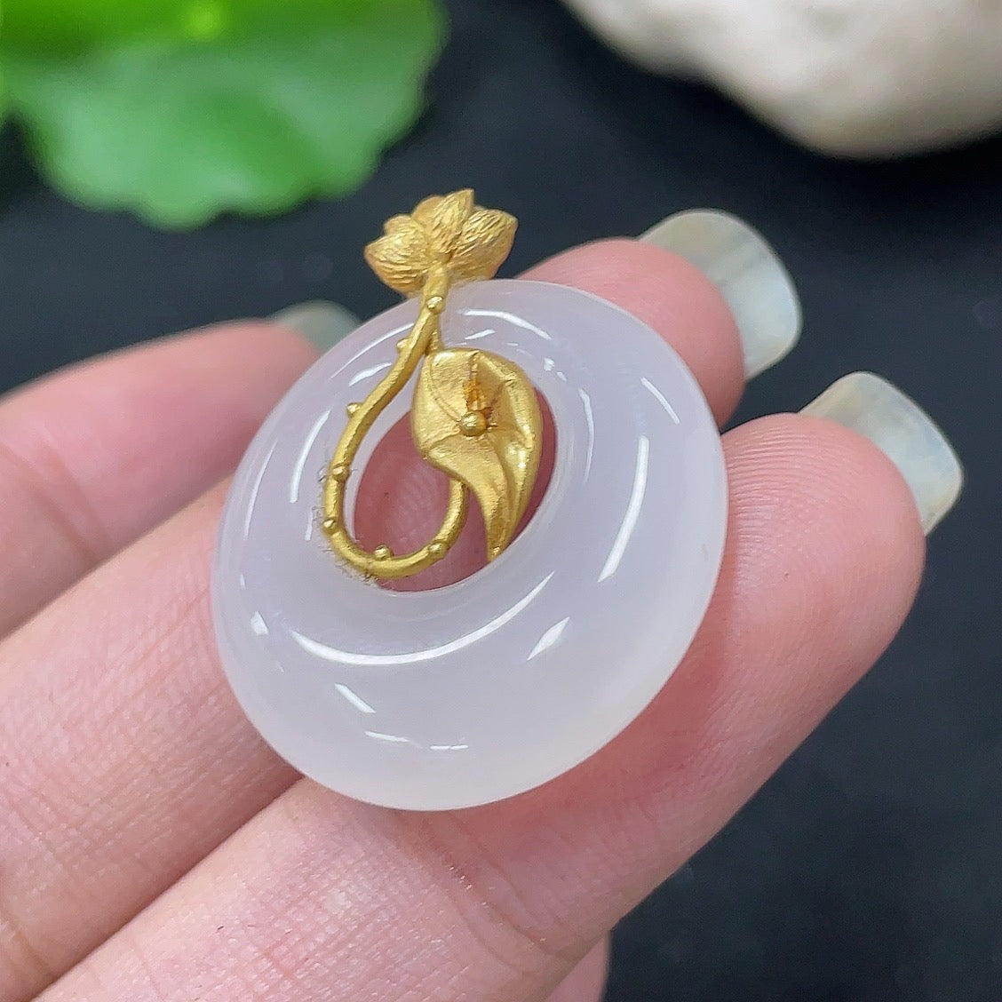 Hetian Jade inlaid pendant necklace with 18K gold setting, HKHQ brand, showcasing a detailed jade centerpiece on a gold chain.