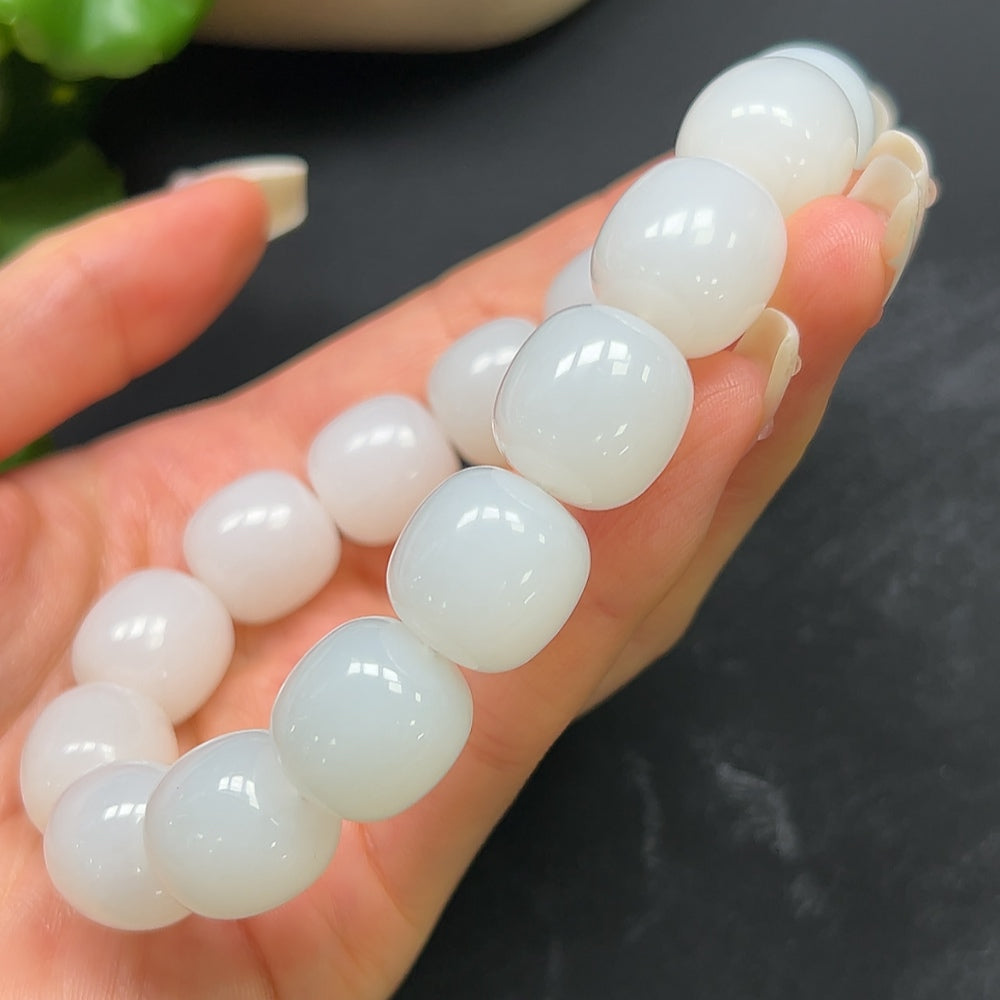Hetian jade bracelet by HKHQ featuring smooth, polished green jade beads, weighing 87.51g, displayed on a neutral background.