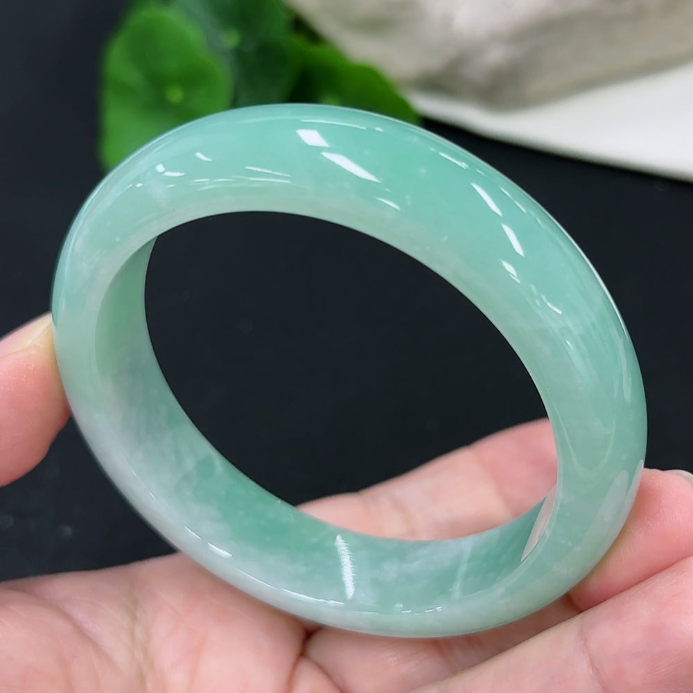 HKHQ jadeite round bangle in size 57.7 with approximately 66g weight, showcasing smooth, polished green jadeite bracelet.