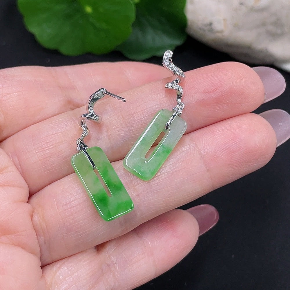 Pair of jadeite earrings with 18K gold and diamond accents, featuring polished jade gemstones and intricate gold detailing