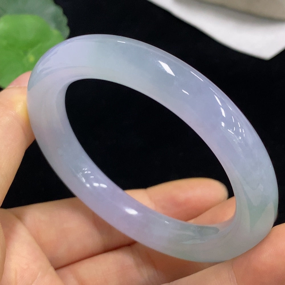 Huiliu Certified Jadeite round bangle showcasing smooth, polished green jade with natural variations and a glossy finish.