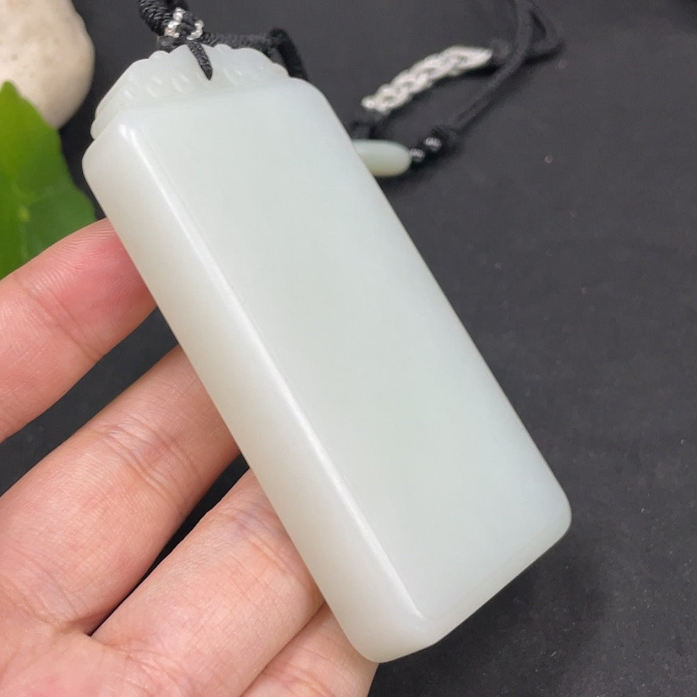Huiliu certified Hetian jade pendant, plain jade jewelry piece with smooth surface and natural green coloration.