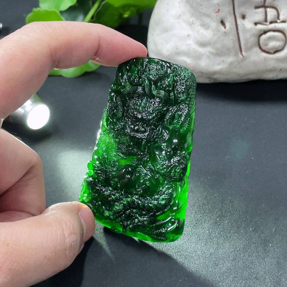 Jadeite dragon pendant from HUILIU HQ, weighing approximately 40g, featuring detailed carved dragon design on smooth jade surface.