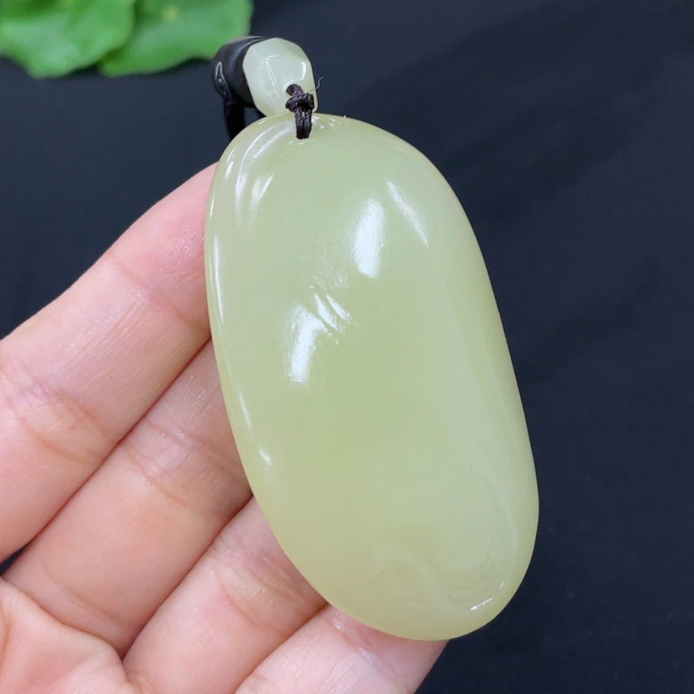 Hetian Jade freeform pendant necklace by HKHQ featuring a smooth, polished jade pendant with natural green and white tones.