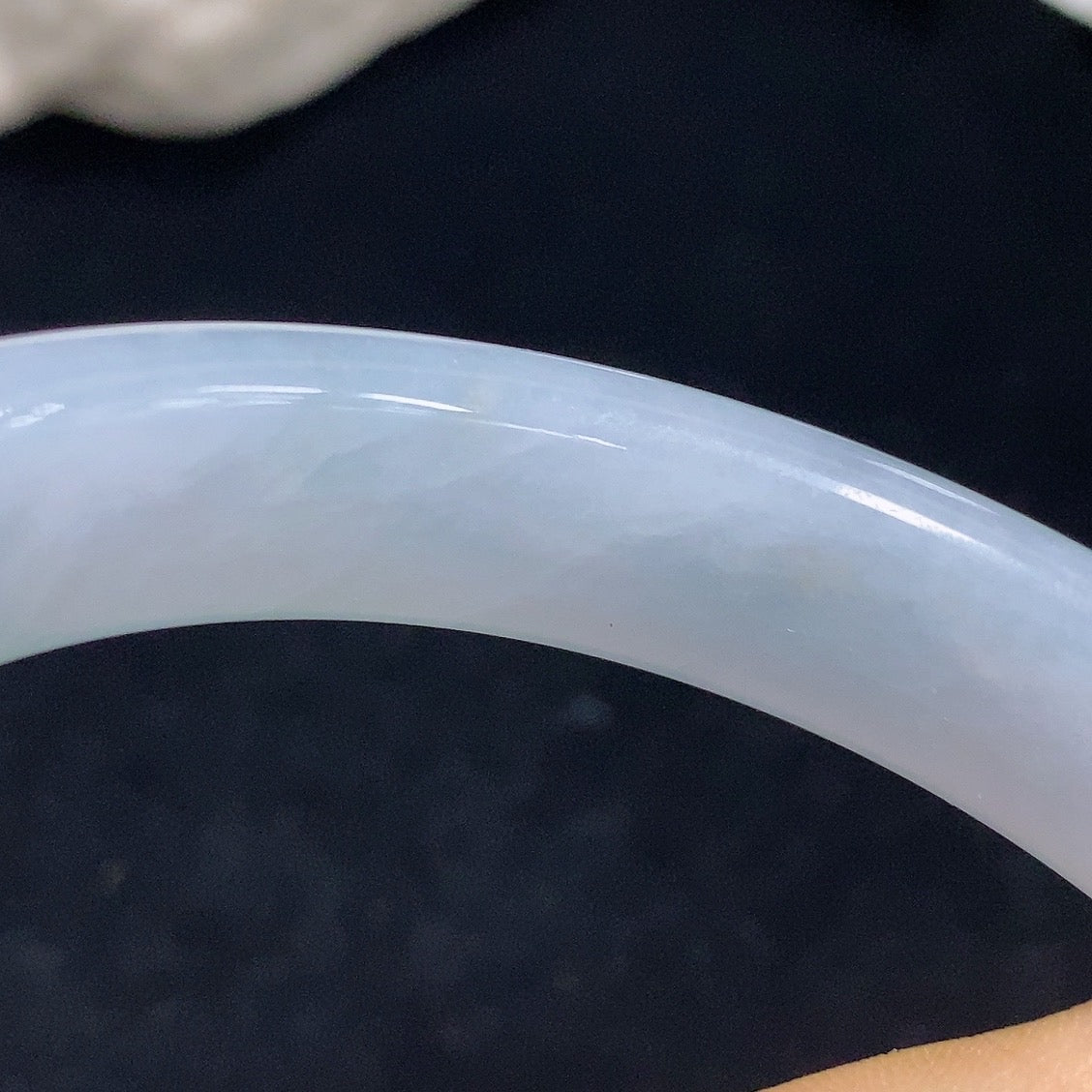 Jadeite round bangle with size 57.5, crafted by HKHQ, showing a smooth, glossy green jade surface and elegant circular shape.