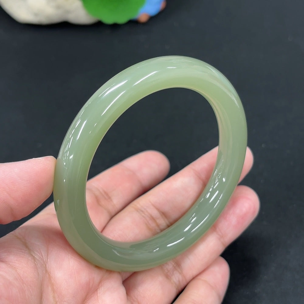 HKHQ Hetian Jade round bangle with size 56.9 and weight approximately 49.3g, showcasing smooth, polished jade craftsmanship.