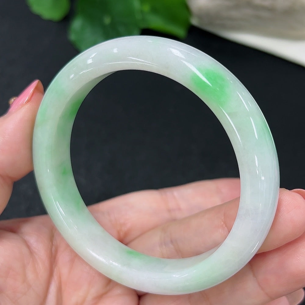 HKHQ jadeite round bangle, size 56, 51.3g, showcasing smooth, polished green jadeite bracelet on a neutral background.