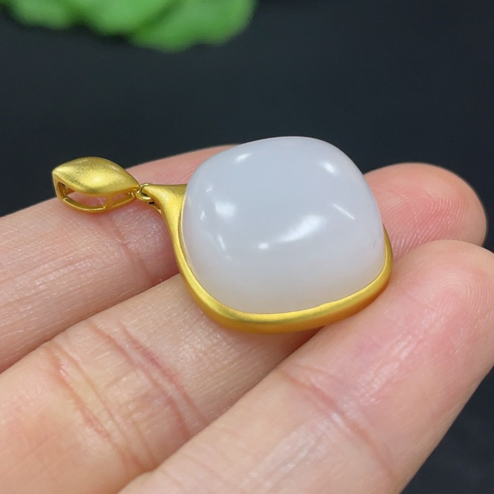 Hetian jade inlaid pendant necklace with 18K gold setting, featuring intricate craftsmanship and a polished finish.