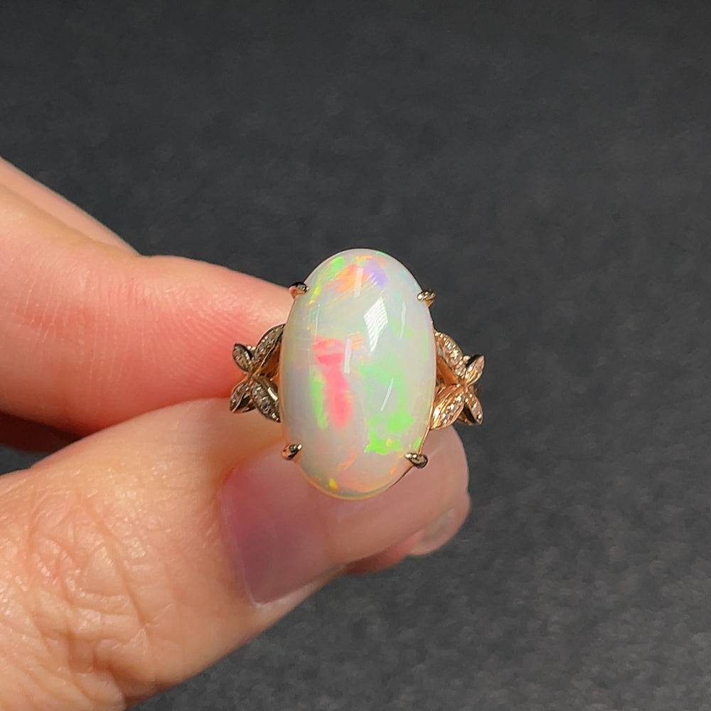 Huiliu certified gemstone opal ring with diamond accents, featuring a vibrant opal centerpiece and delicate detailing.