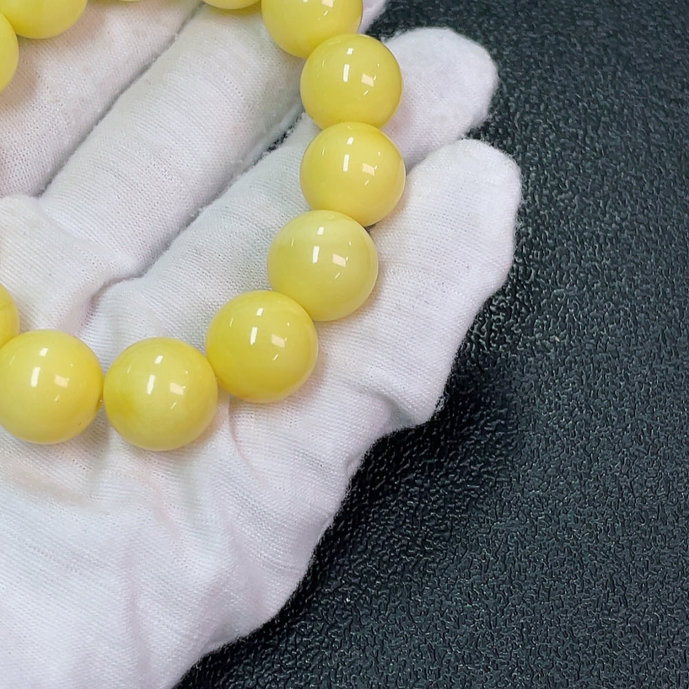 Huiliu Amber Beeswax Bracelet with 13.3mm size, natural amber beads, showcasing warm honey tones and handcrafted detail.