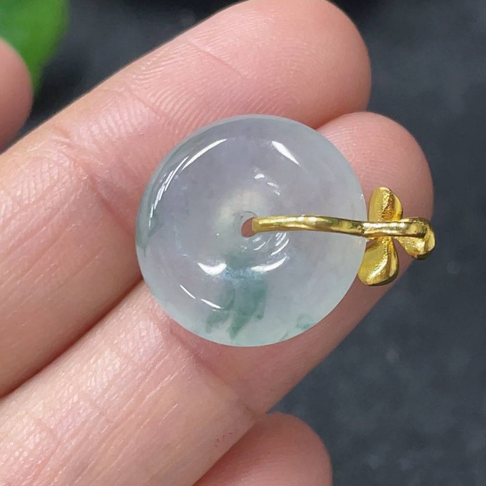 Jadeite peace knot pendant with 18k gold clasp, crafted from smooth green jade, weighs approximately 2.74g.