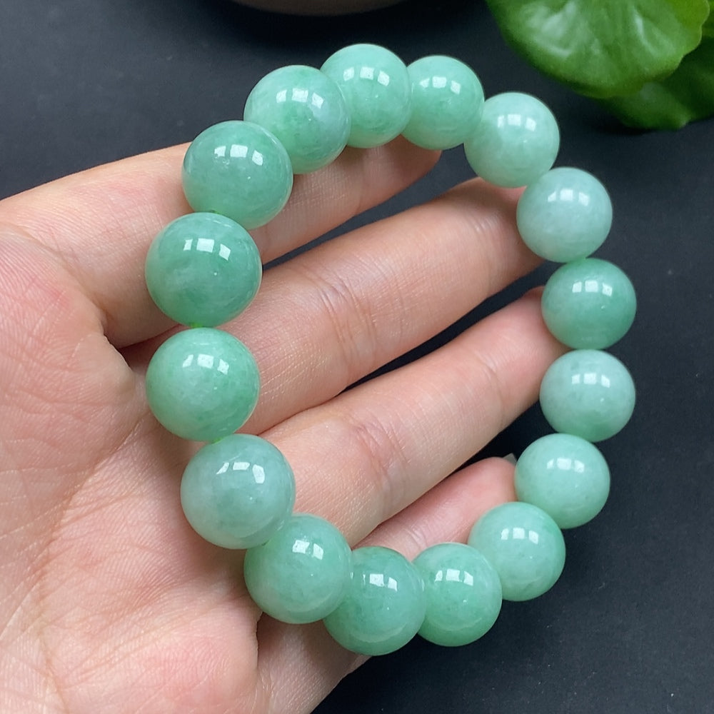 HKHQ jadeite bracelet with 12.8-inch size and 57.85g weight, showcasing smooth, polished green jadeite beads on a flexible bracelet.
