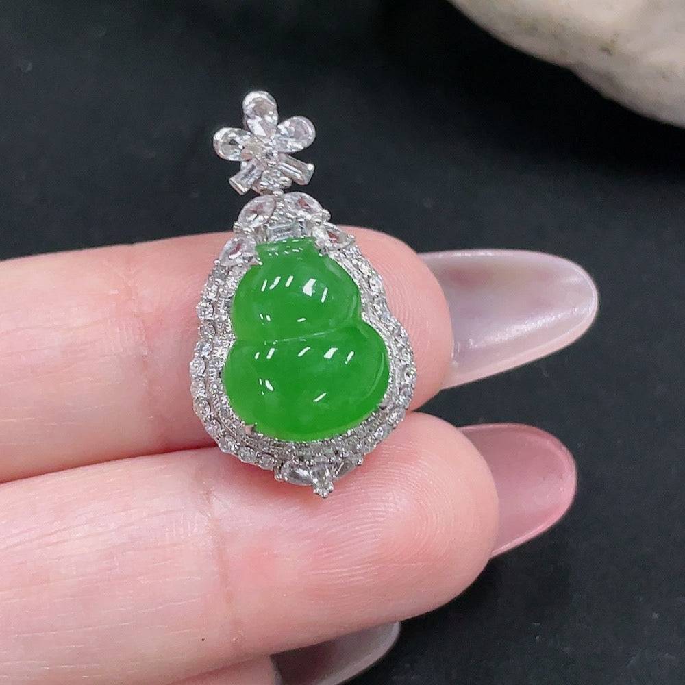 Jadeite gourd pendant with 18k gold and round diamond inlays, showing intricate craftsmanship and polished jade surface.
