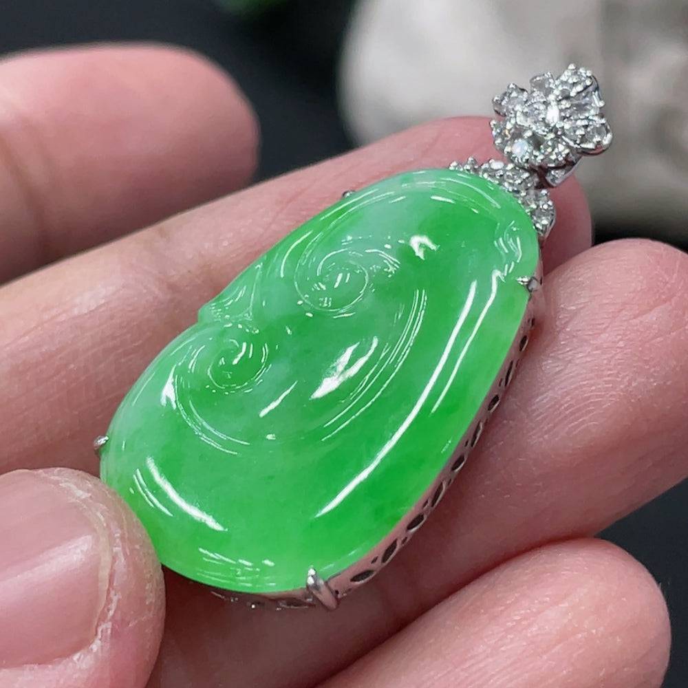 Jadeite Ruyi pendant with 18K gold and diamond accents, showcasing intricate inlay work and a smooth, polished jade surface.