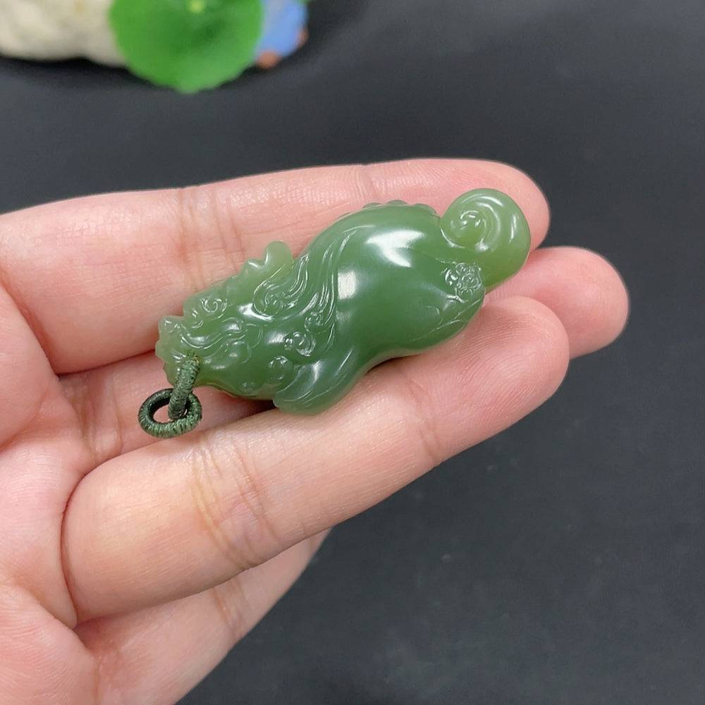 Huiliu certified Hetian jade pendant featuring an auspicious beast design, smooth polished surface and intricate craftsmanship.