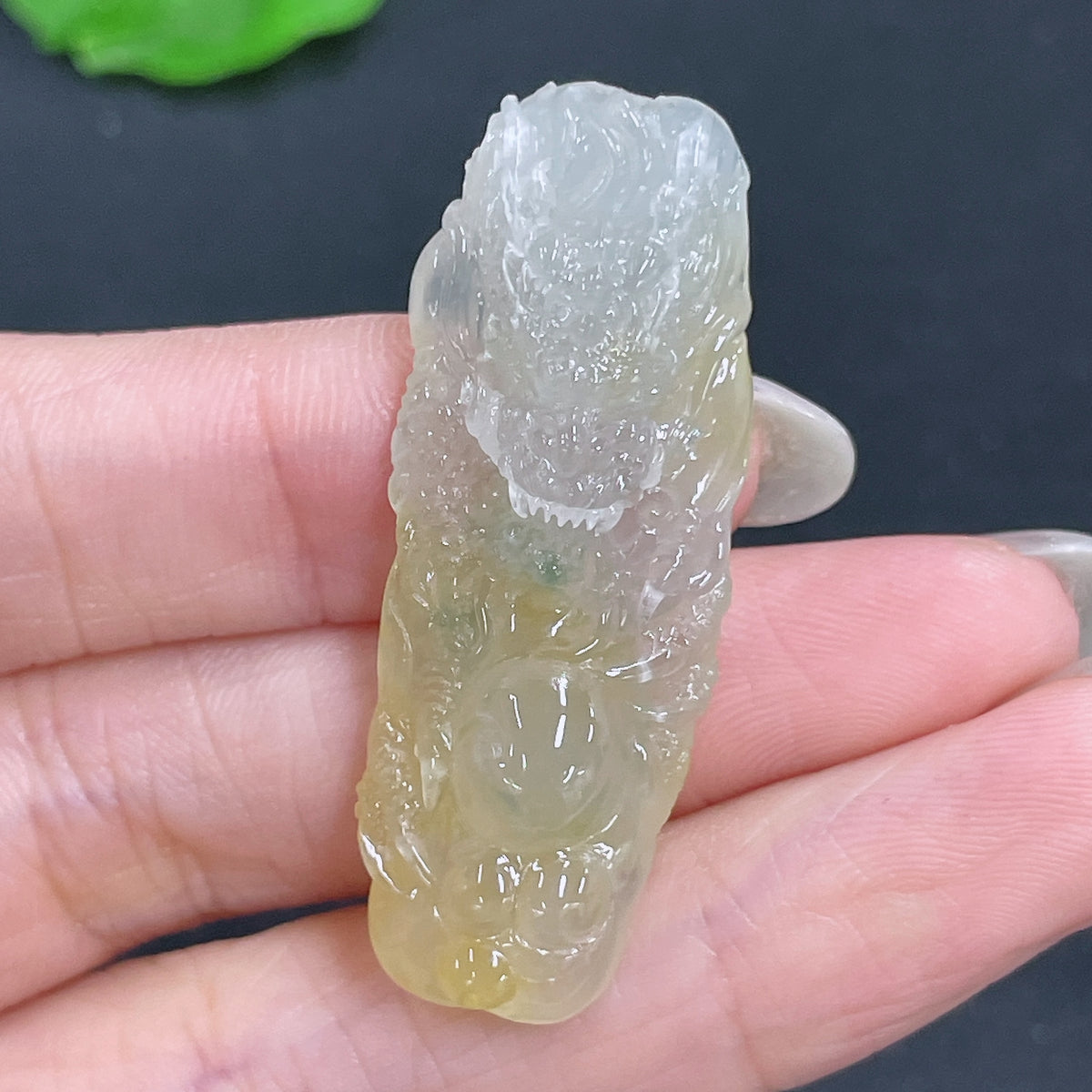 Jadeite pendant featuring a dragon plaque, crafted from green jade, weighing approximately 10g, with intricate carved details.