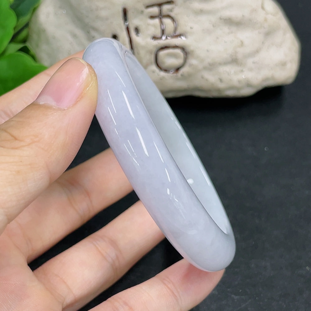 Jadeite round bangle in green with size 55.8 mm and 52.4g weight, showcasing smooth, polished surface and elegant craftsmanship.