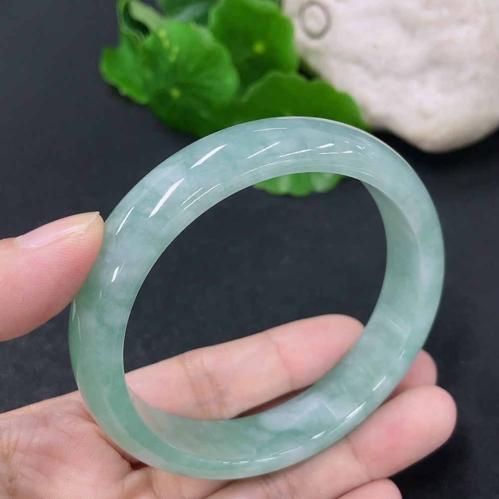 Jadeite round bangle with a 56.8mm diameter, weighing approximately 50.5g, by HKHQ, showcasing smooth, polished green jade surface.