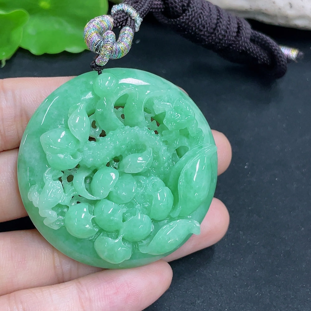 Jadeite lotus pendant necklace with rope, weighing approximately 48.61g, featuring a detailed jadeite lotus design.
