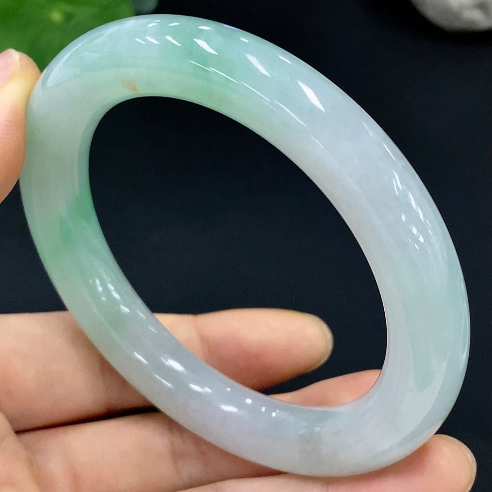 Huiliu Certified Jadeite round bangle showcasing smooth, polished green jade with natural variations and a glossy finish.