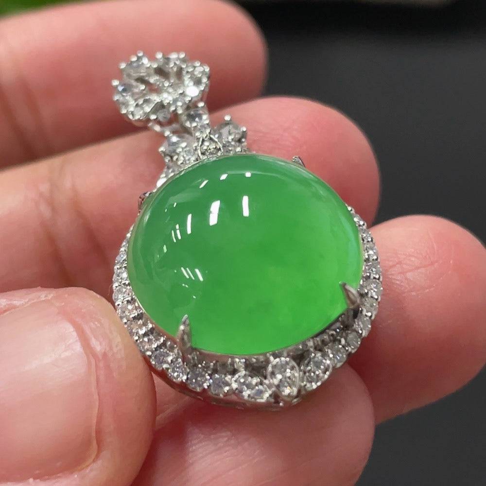 Jadeite cabochon pendant with 18K gold setting and diamond accents, showcasing a polished green jade gemstone.