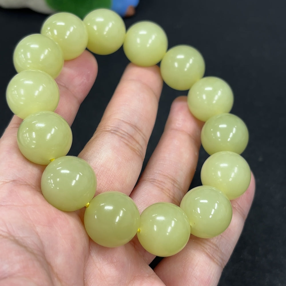 HKHQ Hetian Jade bracelet with 15.9mm beads, showcasing smooth, polished jade stones in natural green tones.