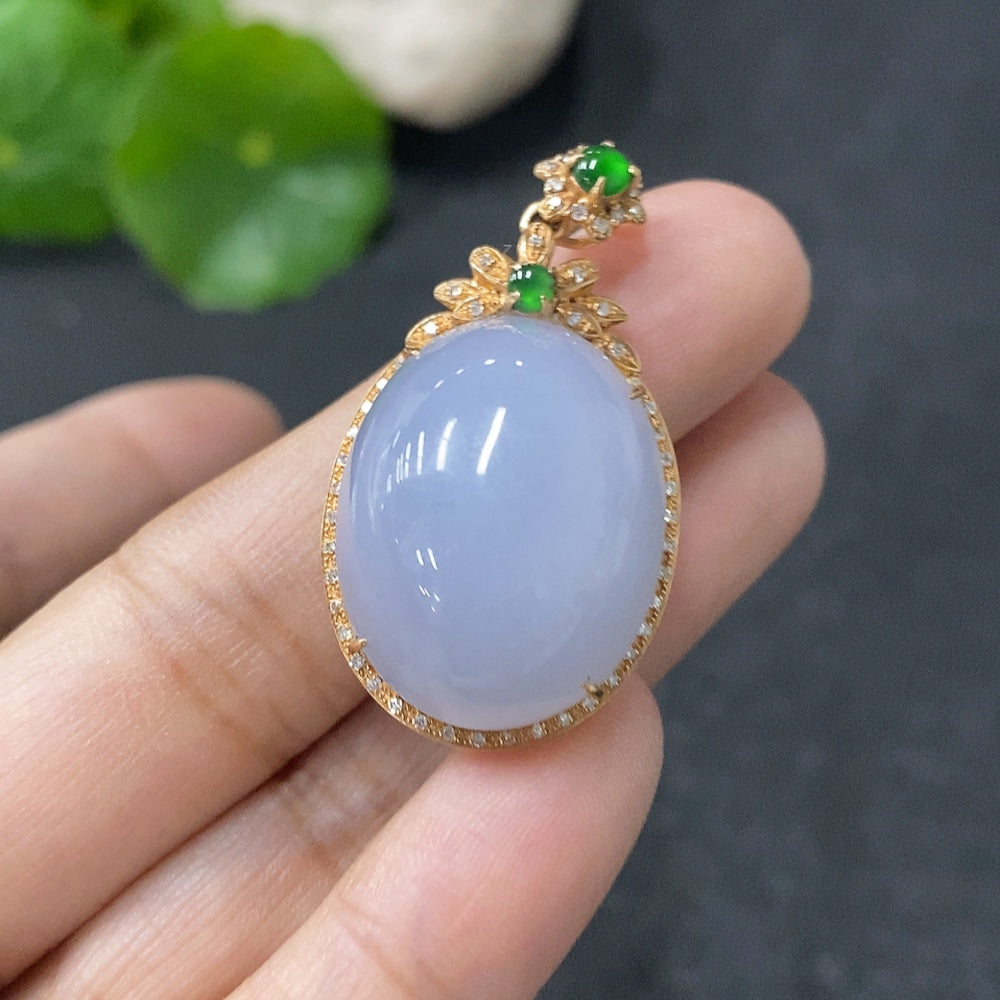 Jadeite bezel-set cabochon pendant with 18k gold and diamond accents, featuring a polished green jade stone and intricate craftsmanship.