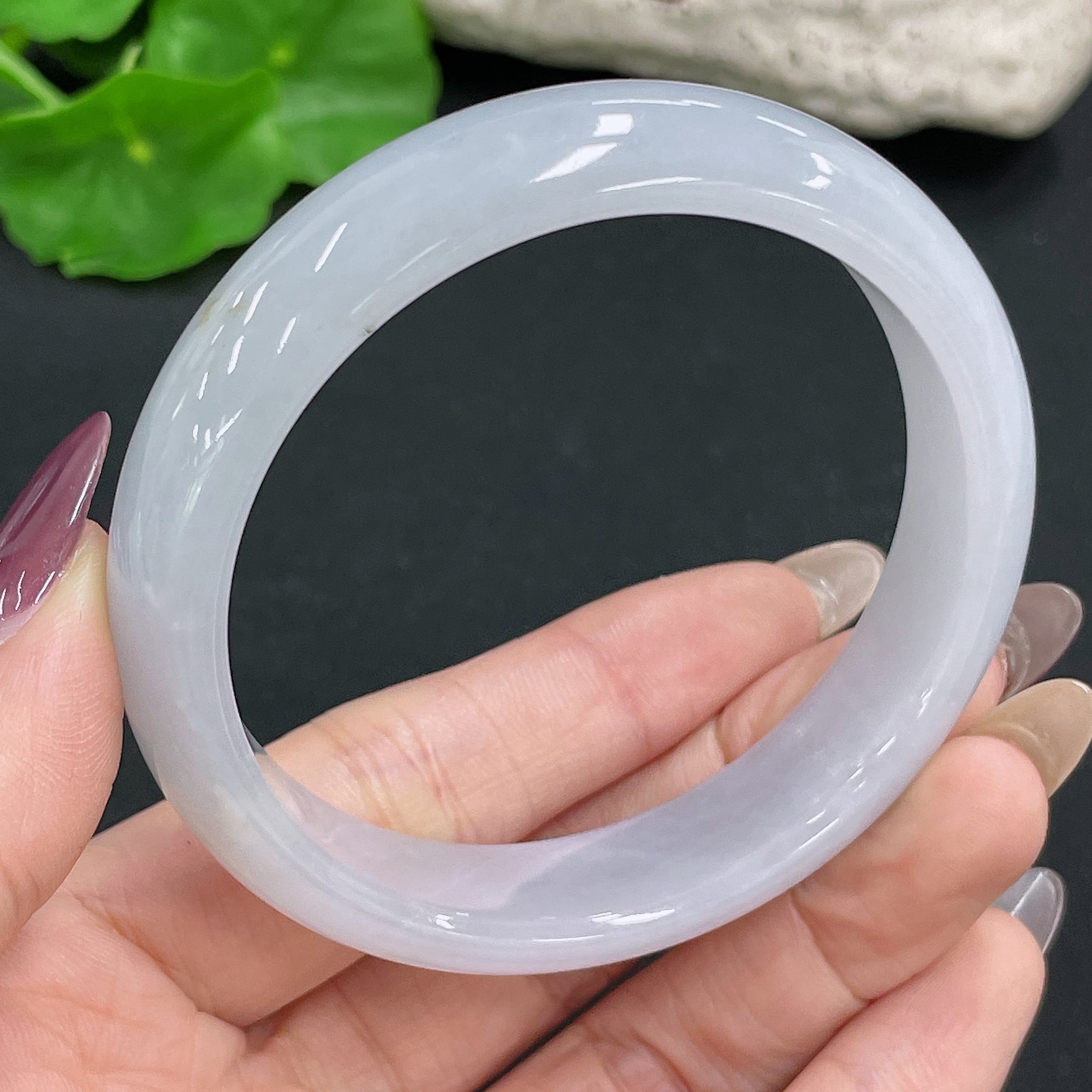 Huiliu certified jadeite round bangle showcasing smooth, polished jade with a natural green hue and elegant circular design.