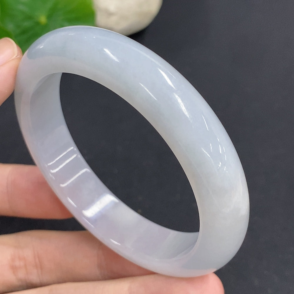 Round jadeite bangle by HKHQ, size 54, showcasing smooth, polished jadeite with a glossy finish and elegant circular design.