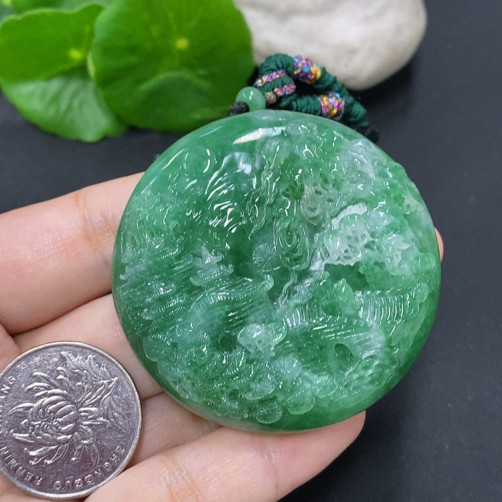 Jadeite landscape pendant on cord necklace, HKHQ brand, showcasing green and white jade with detailed landscape carving.