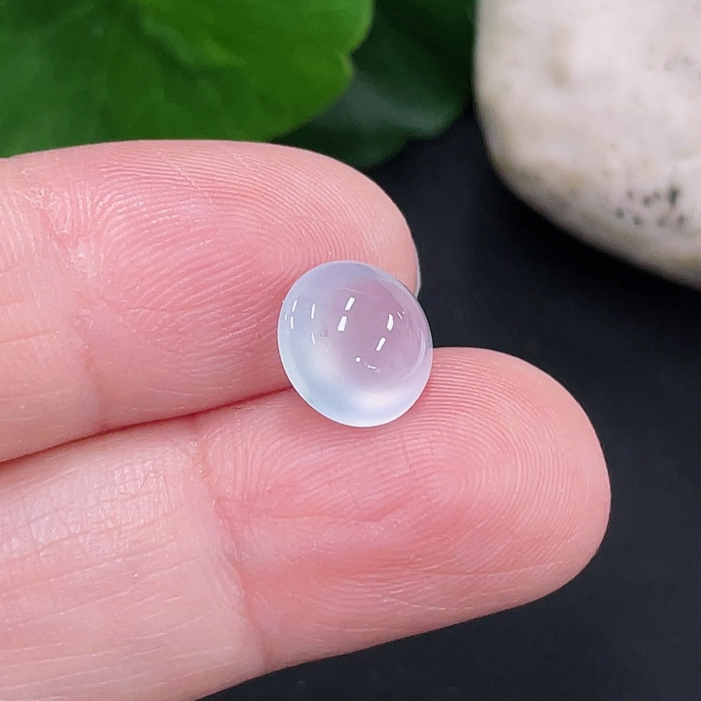 Jadeite cabochon from HUILIU HQ, approximately 0.6g, showcasing smooth, polished jade gemstone with vibrant green hue.