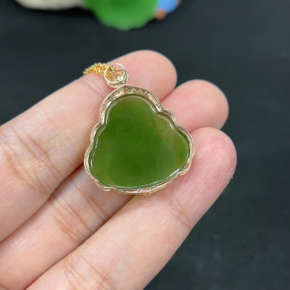 Hetian Jade Buddha pendant necklace with 18K gold setting, showcasing a smooth jade carving on a delicate chain.