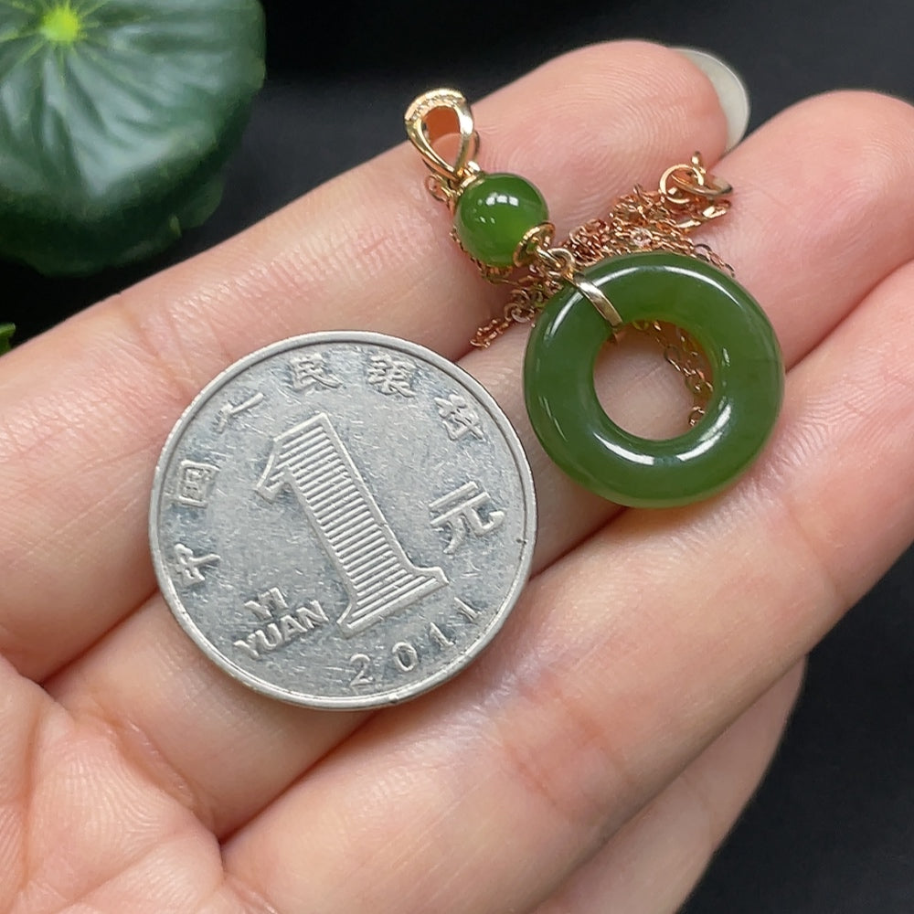 Hetian jade peace knot pendant with 18K gold accents and diamond details, crafted by HKHQ, weighing approximately 3.31g.