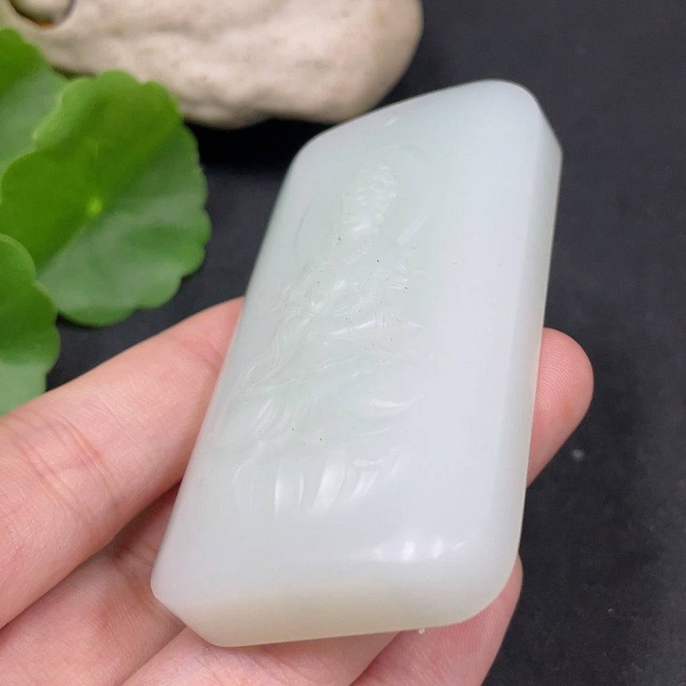 Huiliu Certified Hetian jade pendant featuring Guanyin figure, showcasing smooth, polished green jade craftsmanship.