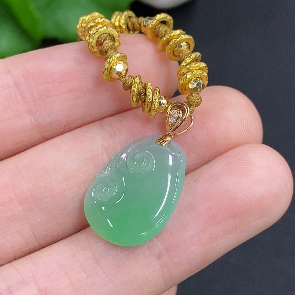 Jadeite Ruyi pendant with 18K gold accents and diamond details, showcasing intricate craftsmanship and smooth jade surface.