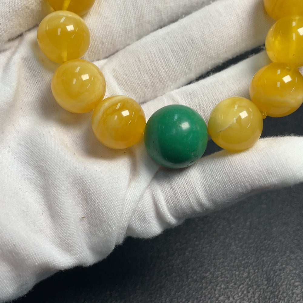 Amber beeswax bracelet with non-natural gemstones, approximately 15.7mm, from HUILIU HQ, featuring a warm amber color and decorative stones.