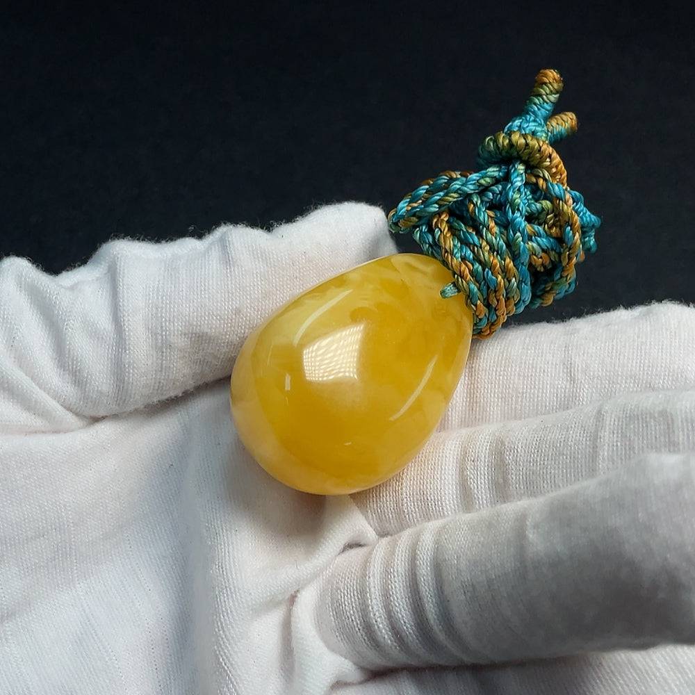 Huiliu Amber Beeswax Pendant with Rope, natural amber jewelry piece showcasing warm honey tones and handcrafted design.